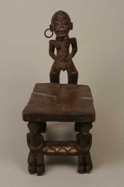 TCHOKWE (chaise), d`afrique : Rép.démoncratique du Congo., statuette TCHOKWE (chaise), masque ancien africain TCHOKWE (chaise), art du Rép.démoncratique du Congo. - Art Africain, collection privées Belgique. Statue africaine de la tribu des TCHOKWE (chaise), provenant du Rép.démoncratique du Congo., 504/900Très ancienne chaise Tchokwe h.T.60cm
h.du plateau 26cm.+ statue 34cm.Chaise à cariatide en guise de dossier;représentant une femme se tenant debout les jambes pliées,les mains posés sur les hanches et 
 mettant son sexe en avant en évidence,avec
les lèvres et le clitoris.Le ventre et le pubis sont scarifiés.Elle porte un bracelet autour de chaque bras et un anneau à l