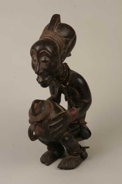 Luba (Buli), d`afrique : Rép.dém. du Congo., statuette Luba (Buli), masque ancien africain Luba (Buli), art du Rép.dém. du Congo. - Art Africain, collection privées Belgique. Statue africaine de la tribu des Luba (Buli), provenant du Rép.dém. du Congo., 544/935.Porteuse de coupe appelée MBOKO, h56cm.bois pigmenté foncé,perles et grelot. Femme accroupie tenant une coupe dans la main,en parfait équilibre.Le rendu expressionniste du visage et des mains tenant la coupe avec couvercle est typiquement de l